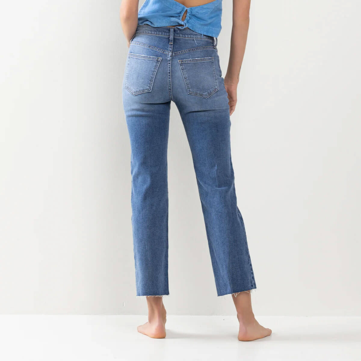 High Rise Raw Hem Straight Leg Jeans blue back | MILK MONEY milkmoney.co | cute clothes for women. womens online clothing. trendy online clothing stores. womens casual clothing online. trendy clothes online. trendy women's clothing online. ladies online clothing stores. trendy women's clothing stores. cute female clothes.