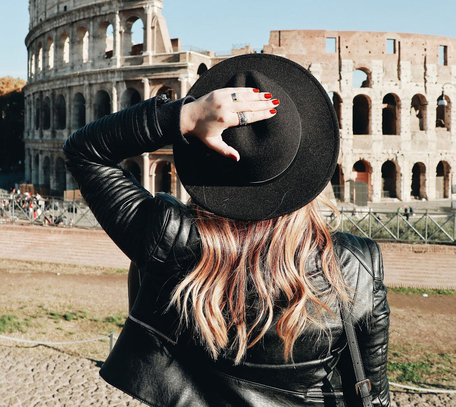 Girl standing in front of Colosseum with back to the camera
