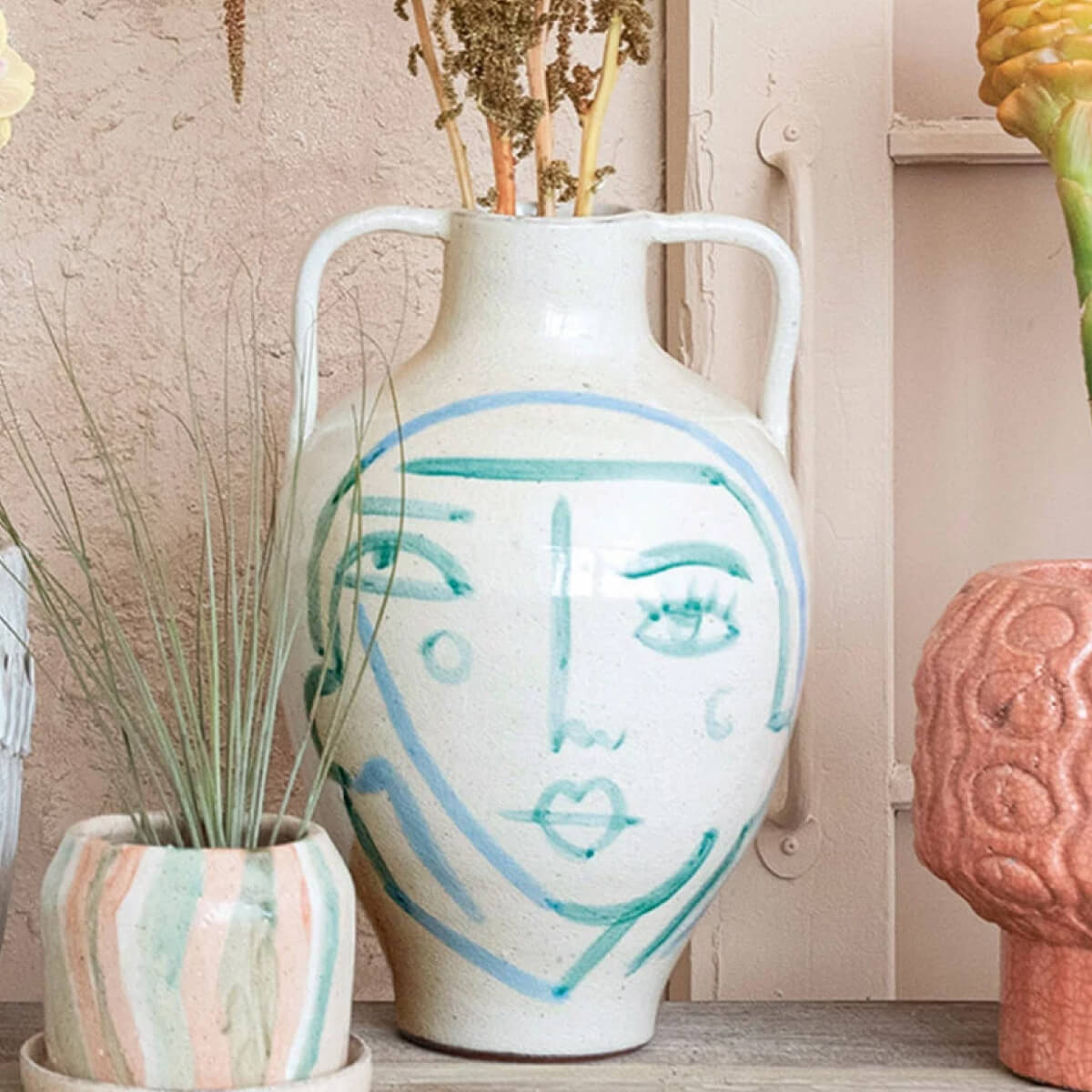 Hand-Painted Abstract Face Terra-cotta Urn front | MILK MONEY milkmoney.co | 	Home decor online, Modern home decor, Luxury home furnishings, Best home decor, Home accessories for sale, Living room furniture sets, Kitchen decor ideas, Wall art for home, Bathroom accessories, Vintage home decor, Minimalist home decor
